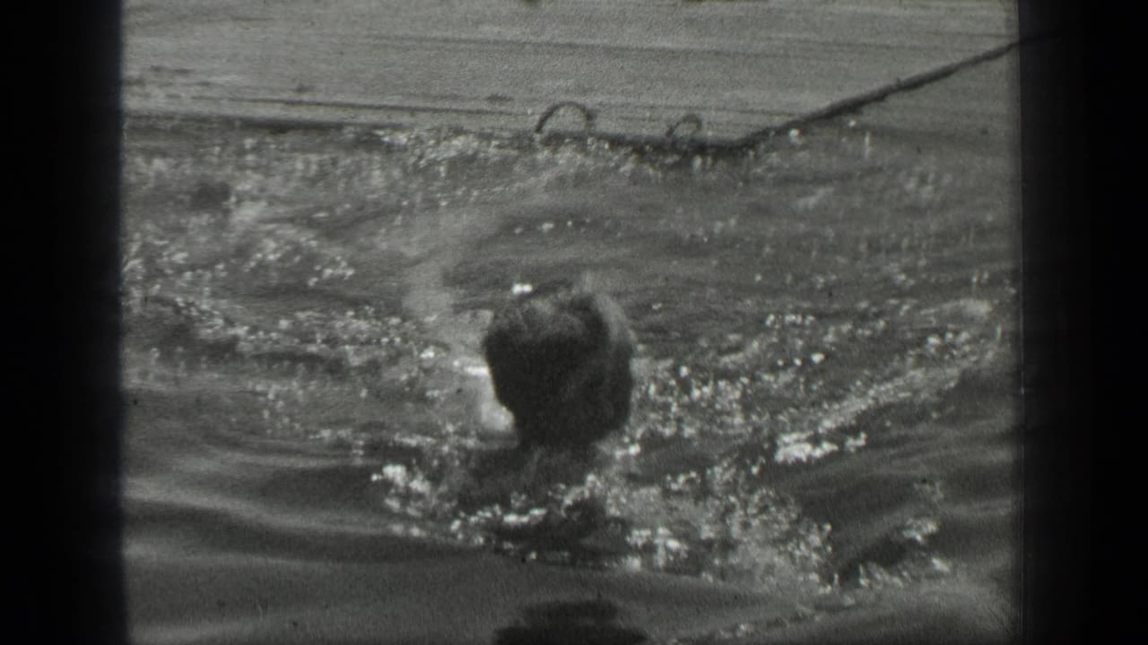Swimmer moves through splashing water with head turned away from camera.