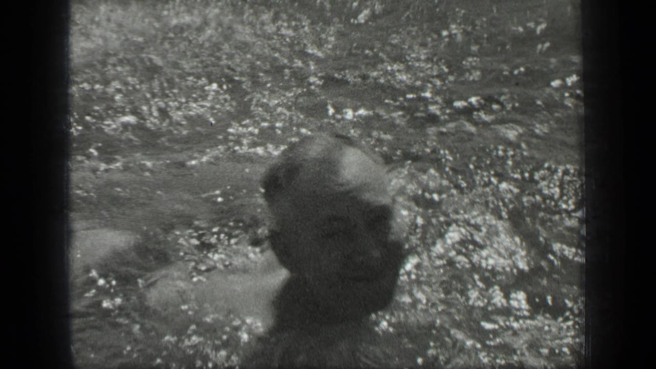 At Long Lake, Canada, a woman appears partly submerged in sunlit water in this 1939 8mm home-movie frame.
