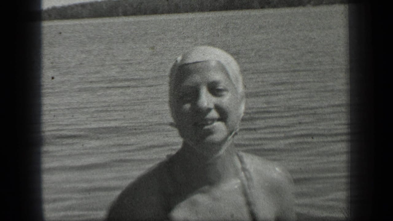 1939 Long Lake, Canada home-movie close view of a woman in a swim cap smiling while standing or floating in shallow water.