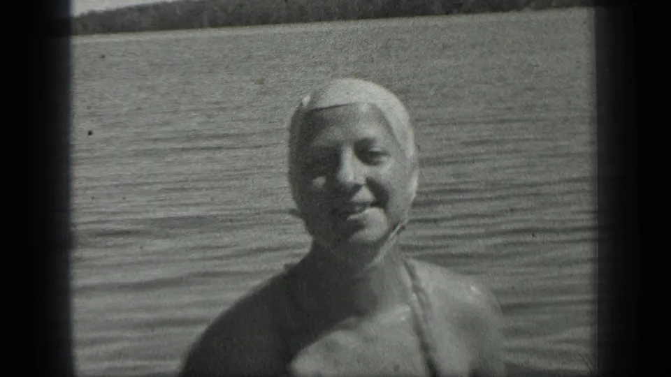 1939 Long Lake, Canada home-movie close view of a woman in a swim cap smiling while standing or floating in shallow water.