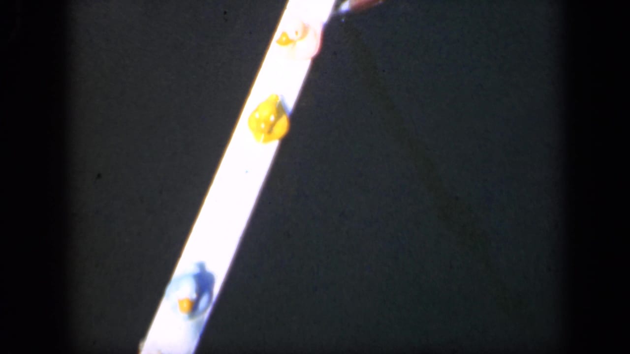 Bright narrow strip with yellow spots against a dark background.