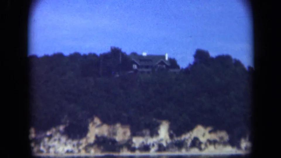 Long Island cliffside house among trees above pale bluffs, recorded in soft 1948 home-movie footage.