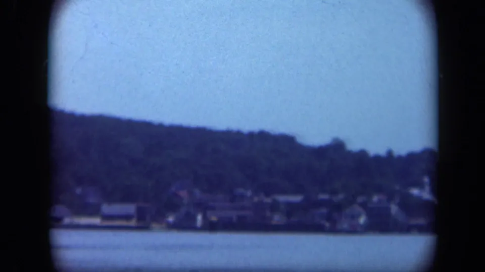 Long Island waterfront houses and wooded hills seen from a moving boat in 1948 8mm footage.