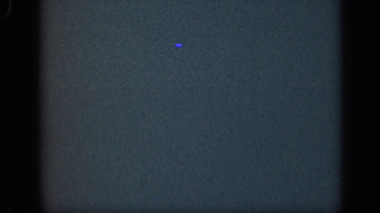 Dark blue-green underexposed film frame with rounded 8mm edges.