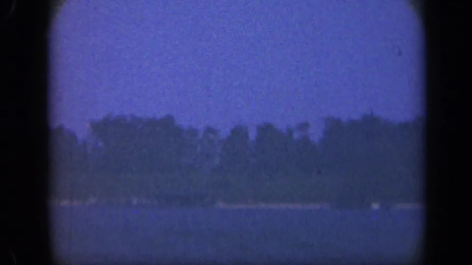 1948 Long Island bay view with open water, distant trees, and dark rounded film-gate borders.