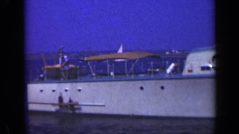 The final 1948 Long Island frame shows a white boat passing through frame with canopy, railings, water, and sky.