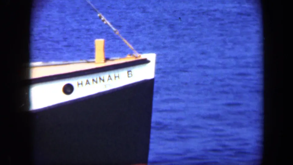 The bow of the fishing boat marked HANNAH B appears on blue water in 1948 Long Island 8mm footage.