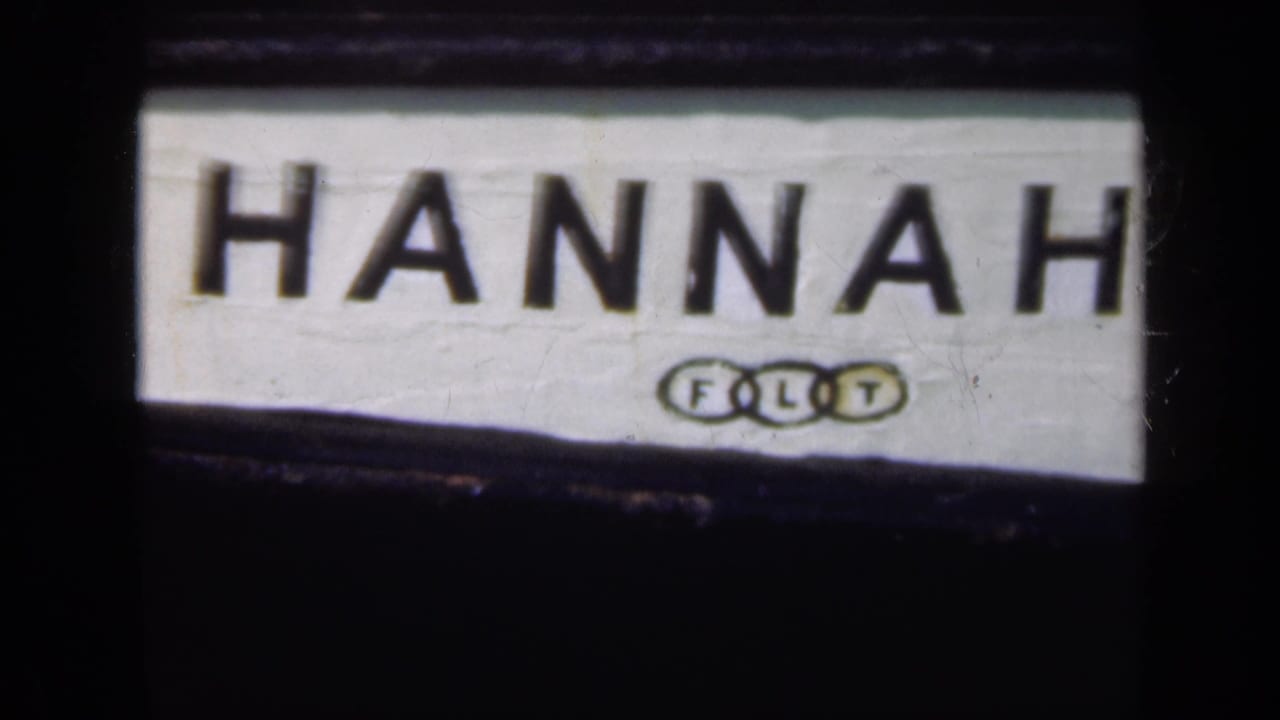 Close view of a white sign reading HANNAH with a small FLT mark below.