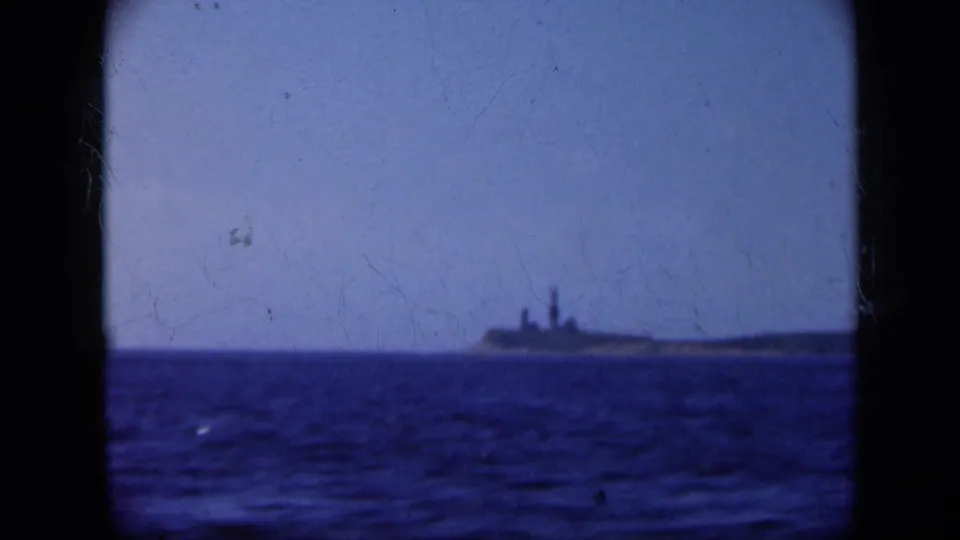 1948 Long Island 8mm view of a distant ship-like silhouette framed by open water and pale sky.