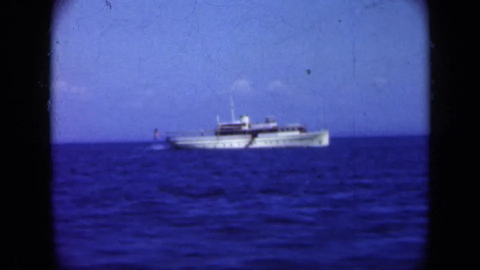 White passenger vessel continues across Long Island waters in a grainy 1948 home-movie frame.