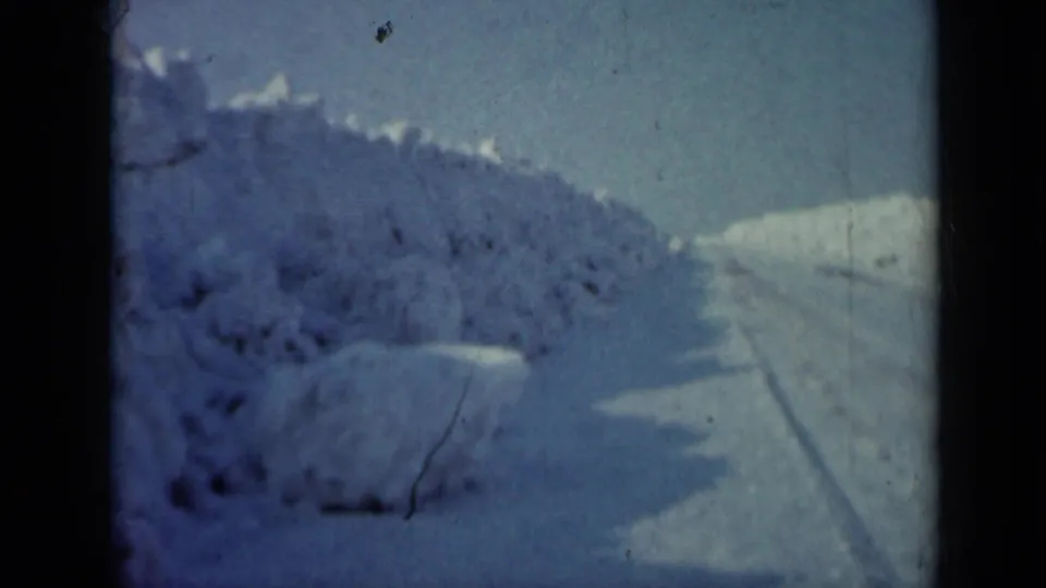1958 Minnesota 8mm frame showing a snow-banked rural road or track after the pasture view.