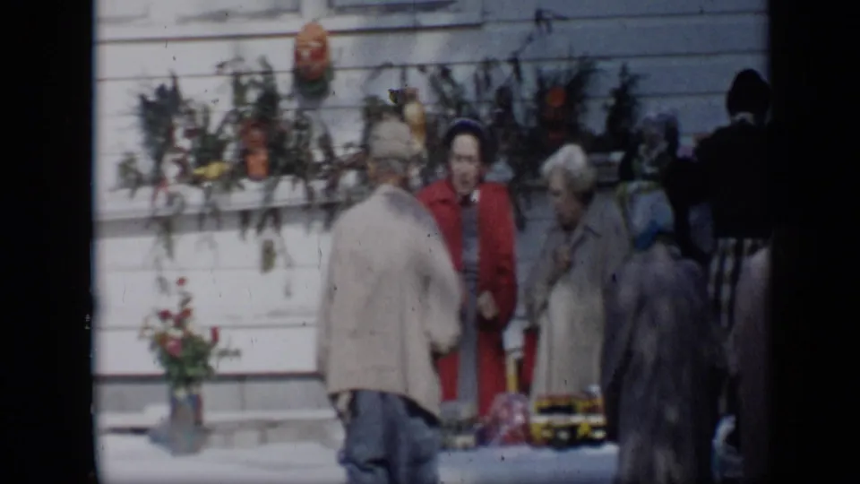 The final 1959 Aledo frame shows women at the flower stand, including one in red, with vases and decorations against white siding.