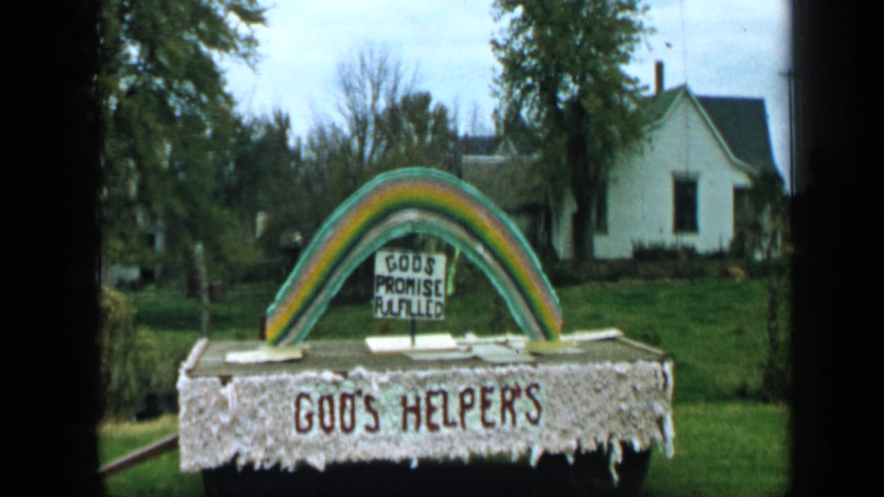 Homemade rainbow display with signs reading GOD'S PROMISE FULFILLED and GOD'S HELPERS.