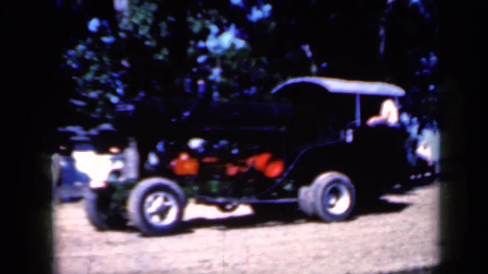 Soft 8mm footage shows the black steam tractor in profile at an Iowa outdoor setting, with a person still visible near the driver's area.