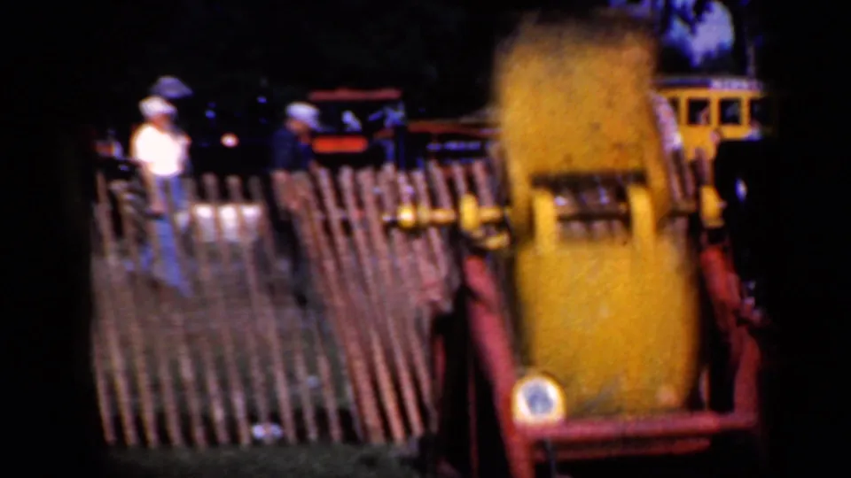 The final frame shows the yellow train-themed attraction by a wooden fence, with spectators and a yellow vehicle partly visible behind it.
