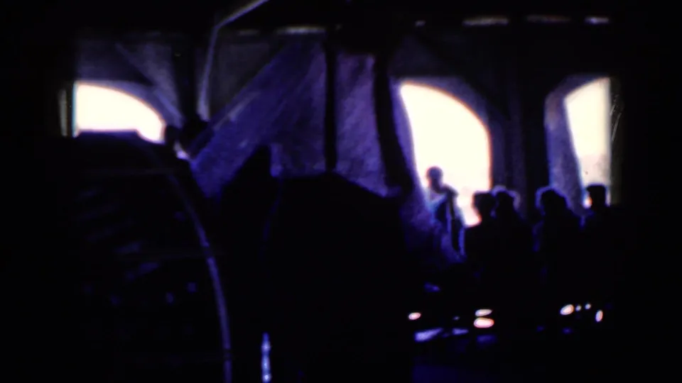 The final Iowa 1959 frame shows workers and machinery mostly in silhouette, with strong contrast and blue-purple 8mm color shift.