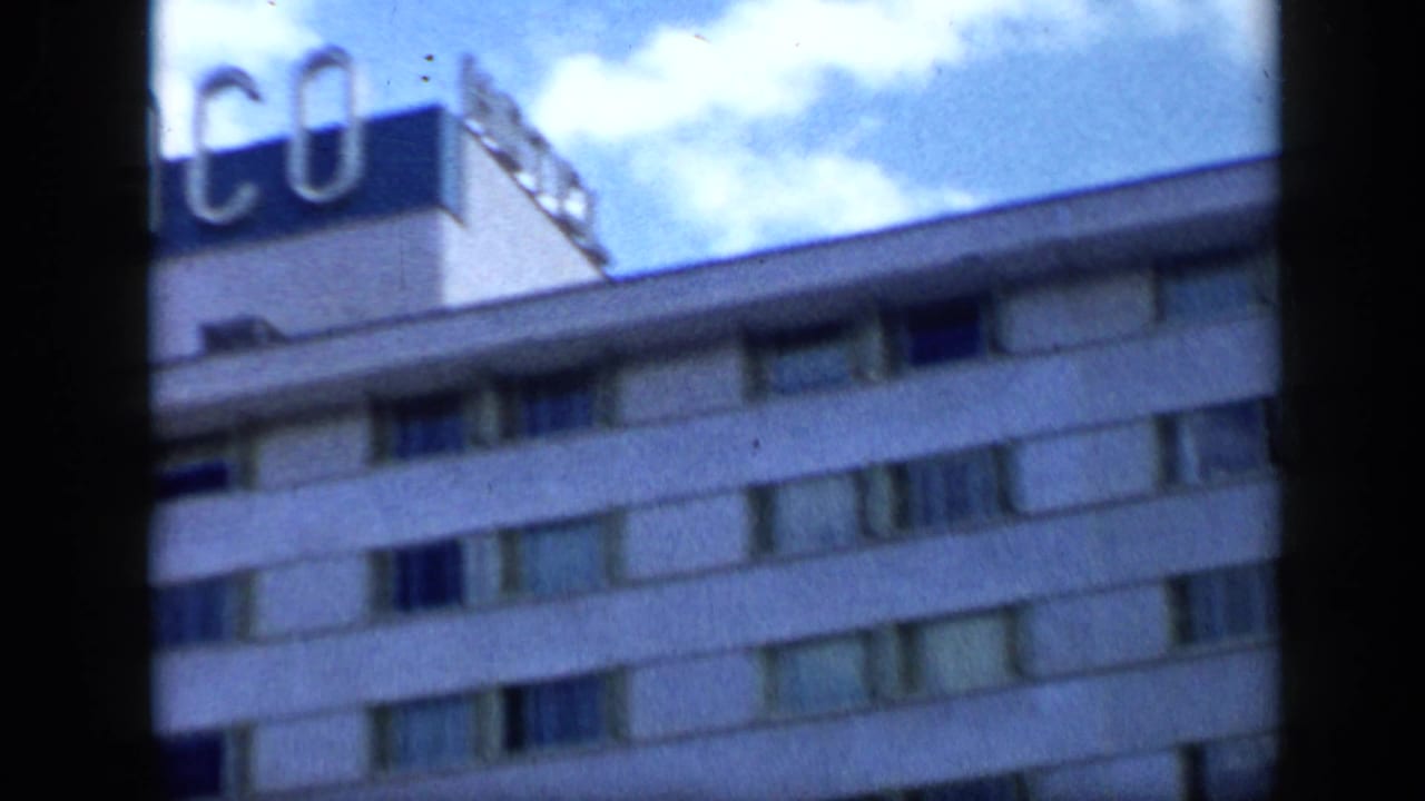 Rooftop edge of the hotel with partial TAMANACO lettering against blue sky.