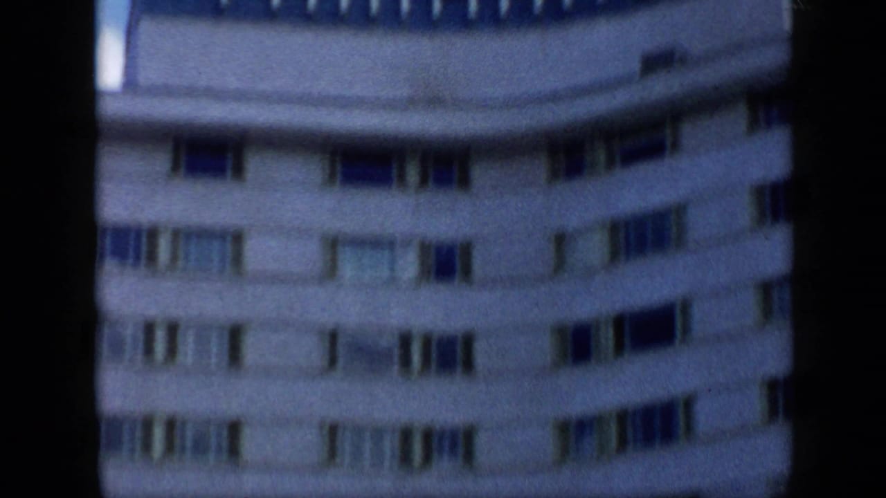 1959 Venezuela frame showing the curved Tamanaco Hotel exterior with repeated window bands and visible 8mm softness.
