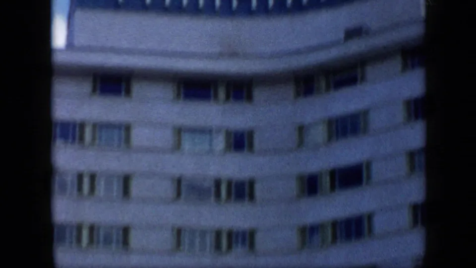 1959 Venezuela frame showing the curved Tamanaco Hotel exterior with repeated window bands and visible 8mm softness.