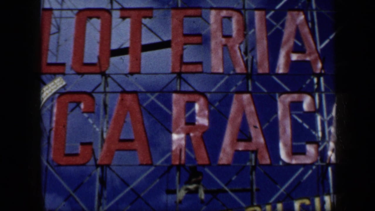 1959 Venezuela 8mm frame showing a red LOTERIA CARACAS sign against a blue patterned sign structure.