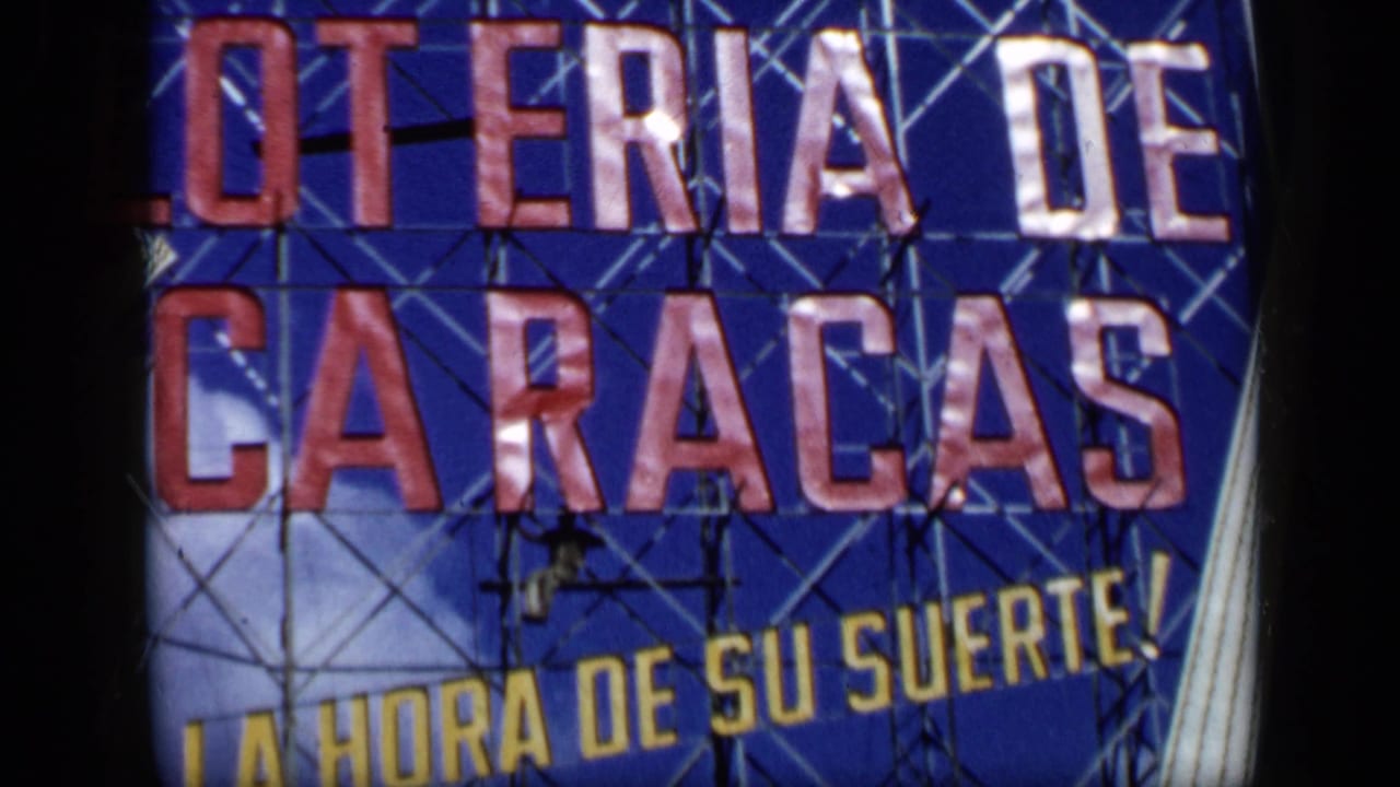 1959 Venezuela 8mm frame showing the sign text and yellow slogan La Hora de Su Suerte beneath scaffolding.