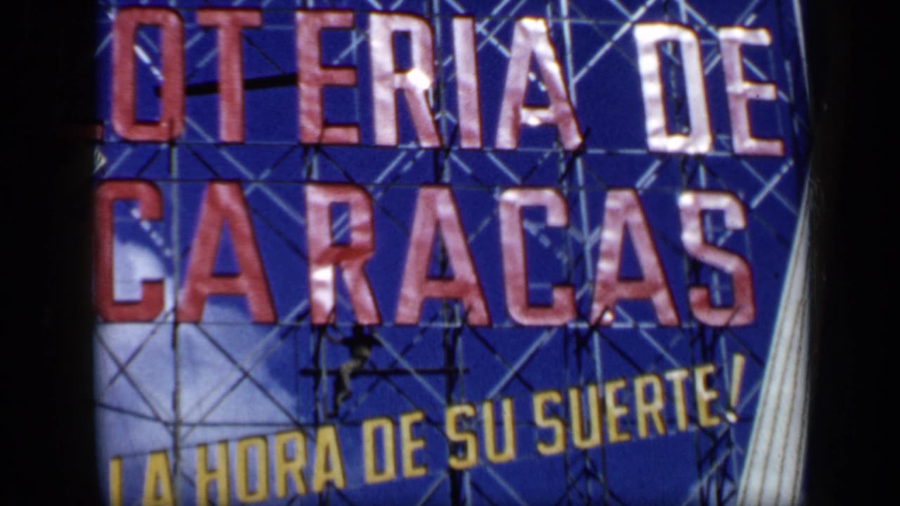 1959 Venezuela 8mm frame showing a blue Loteria de Caracas sign with bold red letters and yellow slogan text.