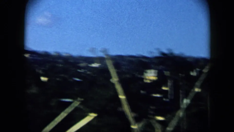 Fast 8mm pan from a boat in Venezuela, with blurred rigging crossing the shoreline and distant hillside.