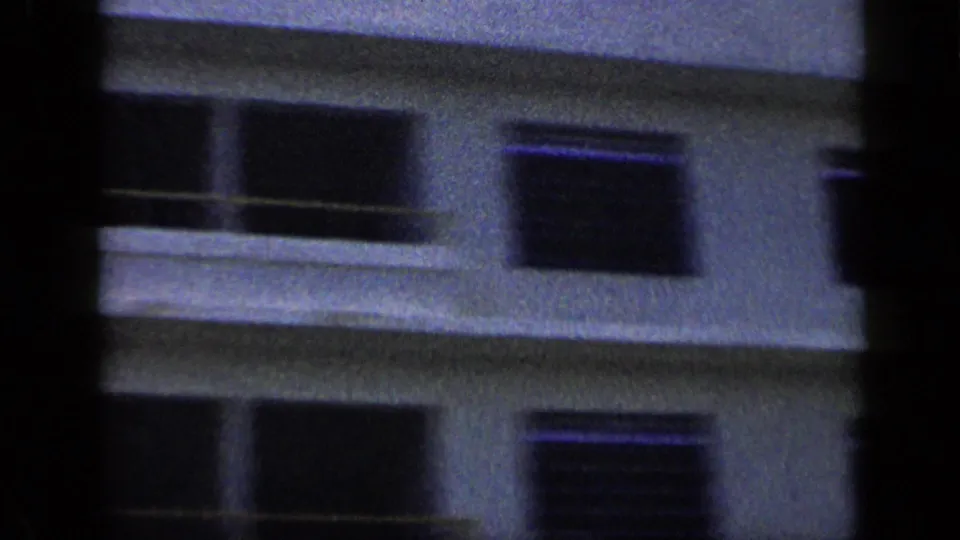 1959 Venezuela home-movie frame showing a modern hotel exterior with balconies and shaded windows.