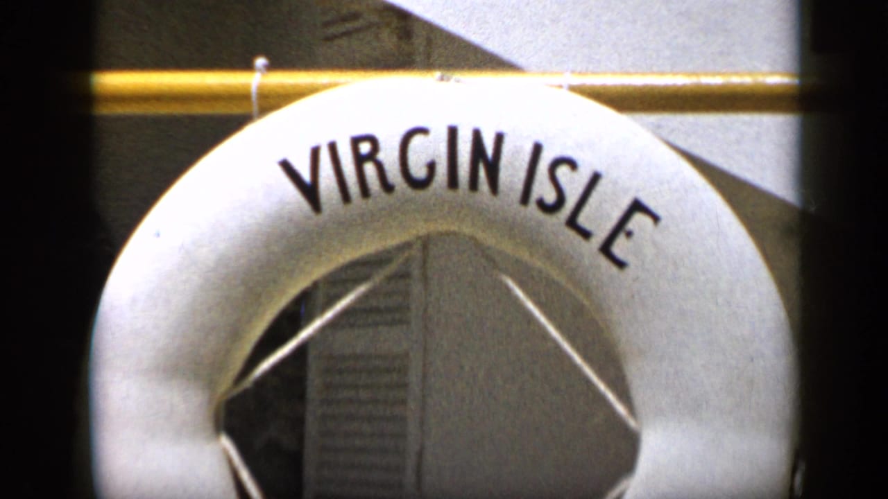 1959 Venezuela 8mm frame showing a white Virgin Isle buoy cropped close against a rail and wall panels.