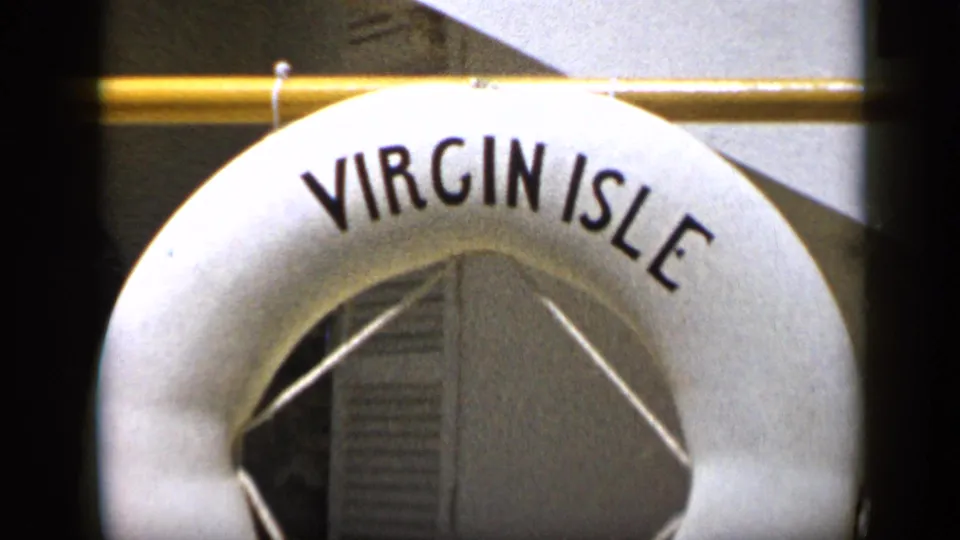 1959 Venezuela 8mm frame showing a white Virgin Isle buoy cropped close against a rail and wall panels.