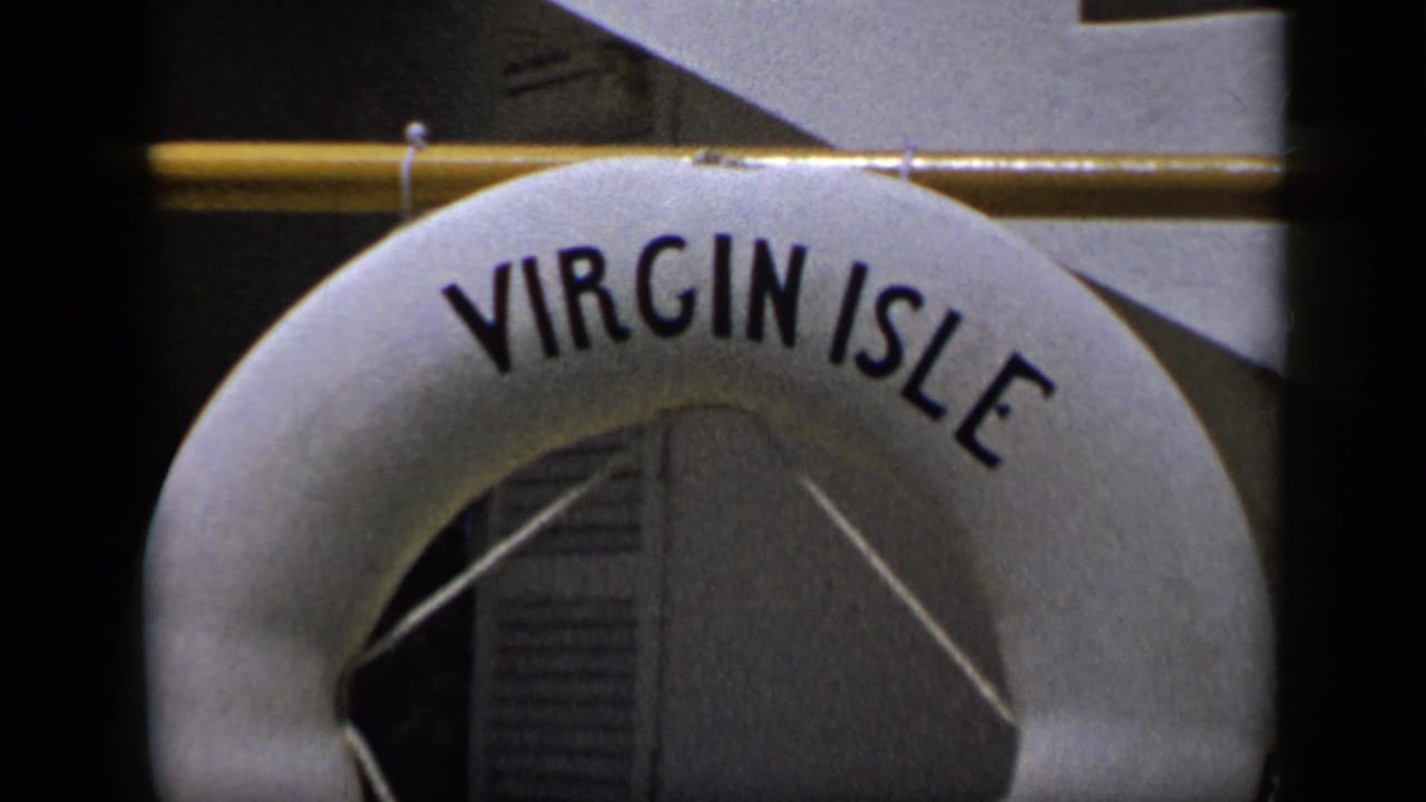 1959 Venezuela home-movie frame with the upper half of a Virgin Isle buoy and rail in close-up.