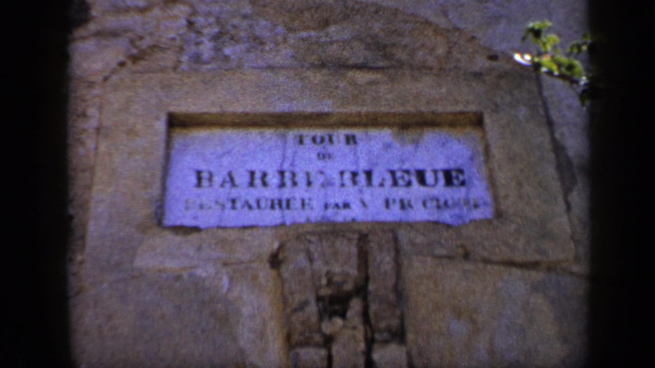 1959 Venezuela 8mm frame showing a weathered wall sign, partly readable as Barquisimeto, with soft focus and dark frame edges.