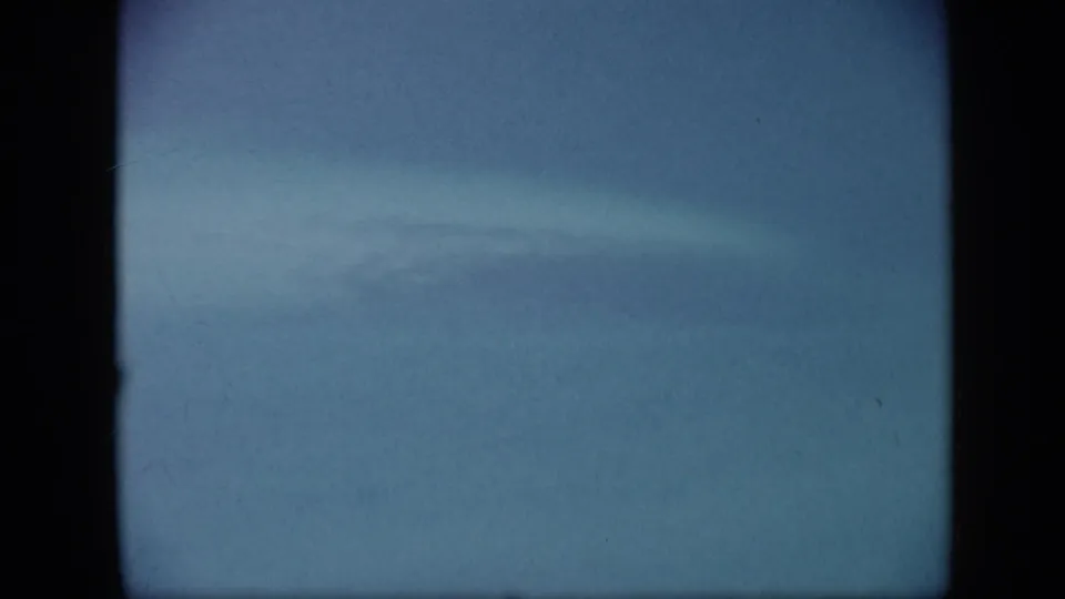 Final 1959 Venezuela coastal home-movie frame emphasizing open turquoise water with soft focus and visible 8mm grain.