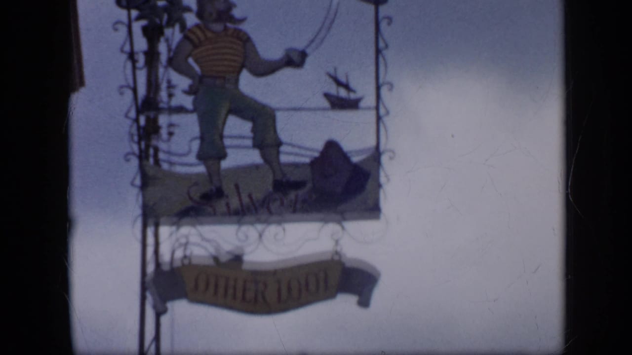 Closer lower view of the Continental sign structure, with the illustrated figure above a second shop sign.
