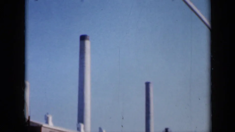 The final 1961 Missouri frame shifts to smokestacks and a clear blue sky, suggesting the surrounding factory complex.