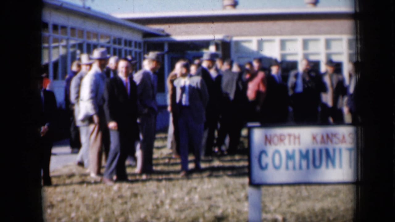 Men gather on the lawn beside a North Kansas City Community Y sign in 1961 Missouri footage.