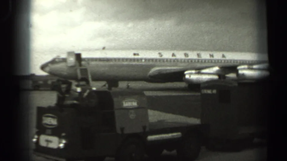 A Sabena passenger plane waits on the Missouri tarmac in 1961, with ground equipment positioned near the aircraft.
