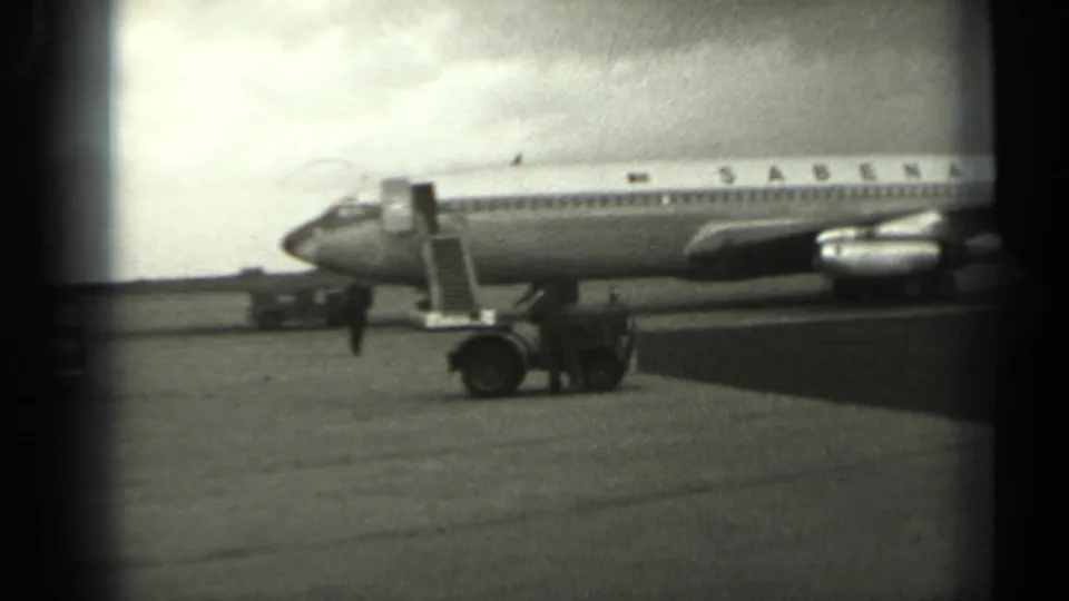 1961 Missouri 8mm frame showing a Sabena jet from the front side, with access ladder lowered and a small service vehicle nearby.