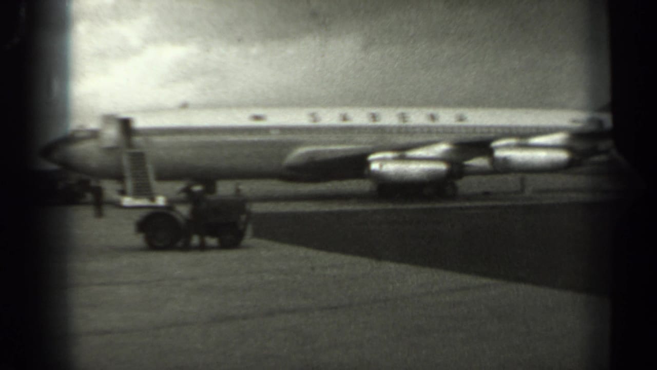Sabena jetliner on an airport tarmac with mobile stairs and ground equipment nearby.