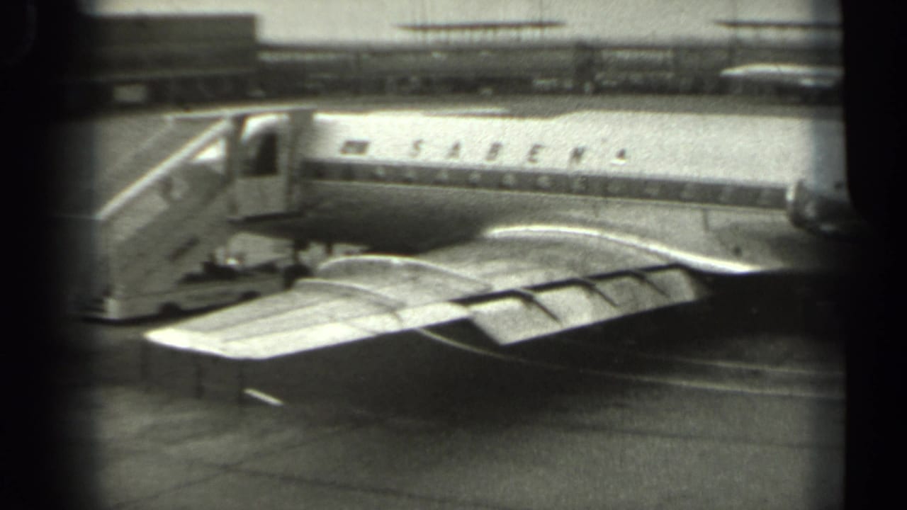 Sabena passenger airplane parked on a tarmac with wing and fuselage visible.