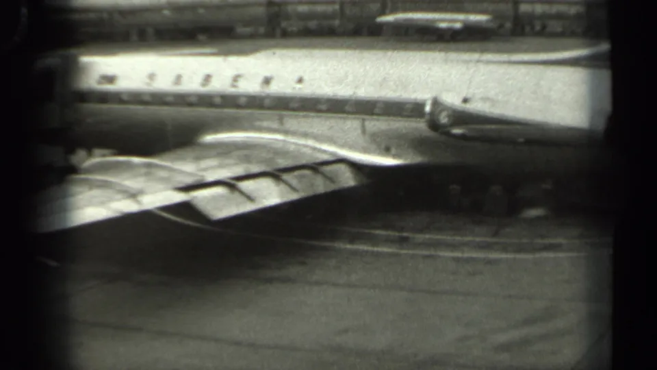 Low-angle 1961 Missouri view of a Sabena aircraft parked on the tarmac, with the wing foreground and fuselage lettering visible.