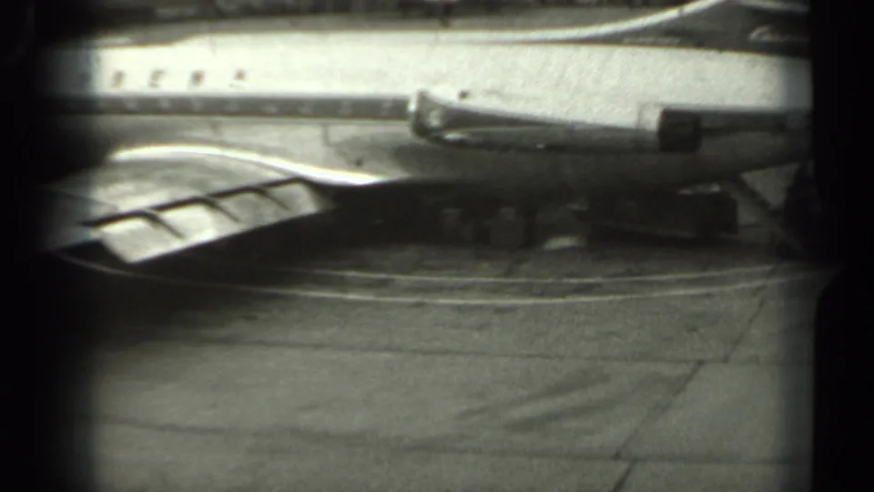 1961 Missouri airport frame with the Sabena aircraft over the wing foreground and ground-service equipment beneath the fuselage.