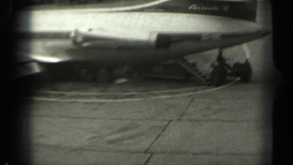 1961 Missouri frame showing the rear of the Sabena aircraft with stairs extended and a worker near ground-service equipment.