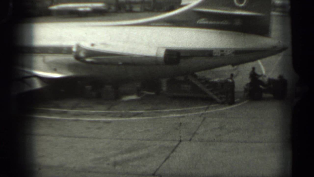 1961 Missouri 8mm frame showing a Sabena aircraft on the tarmac, with small ground crew figures and service activity near the plane.