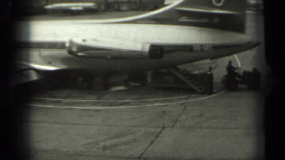 1961 Missouri 8mm frame showing a Sabena aircraft on the tarmac, with small ground crew figures and service activity near the plane.