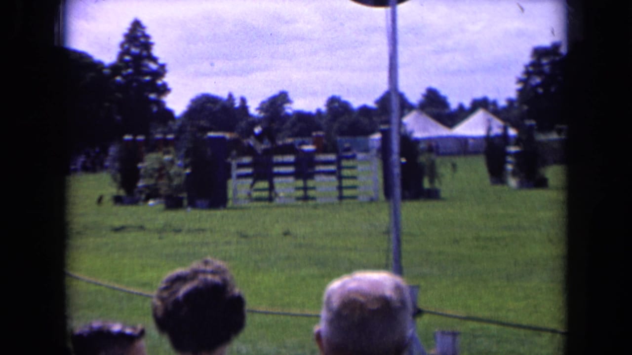 A wider 1963 England view shows show-jumping fences on a green field, with spectators' heads in the foreground and tents beyond.