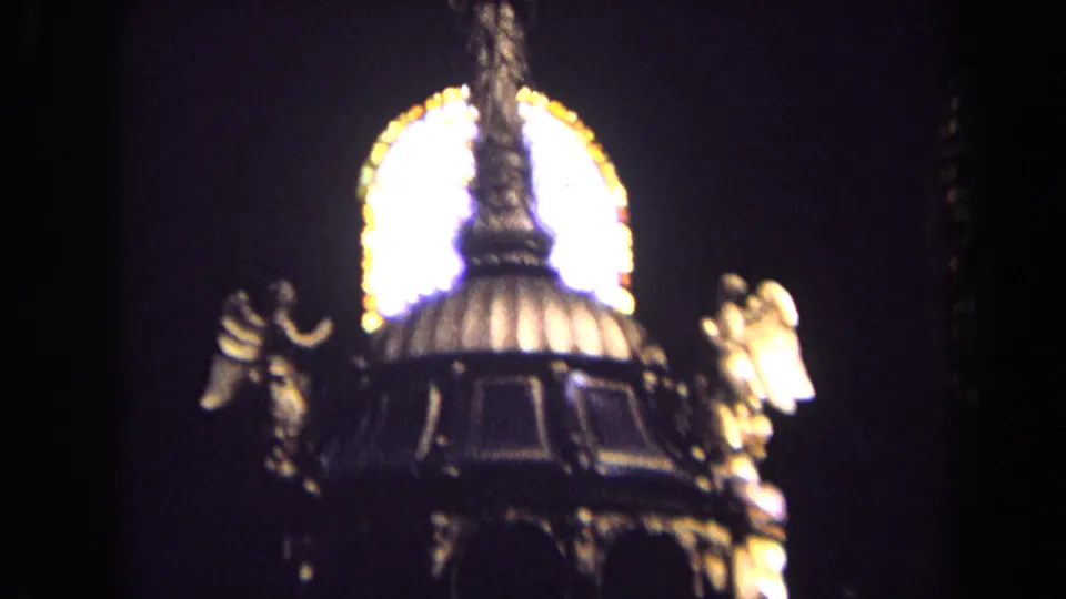 1963 England church interior frame showing a close, soft-focus view of angel statues and an ornate canopy before stained glass.