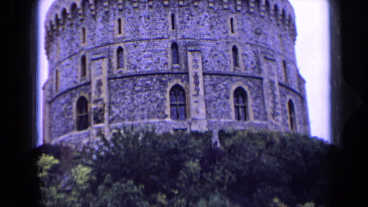 Low-angle visitor-shot view of the castle tower in England, softened by 8mm grain and color shift.