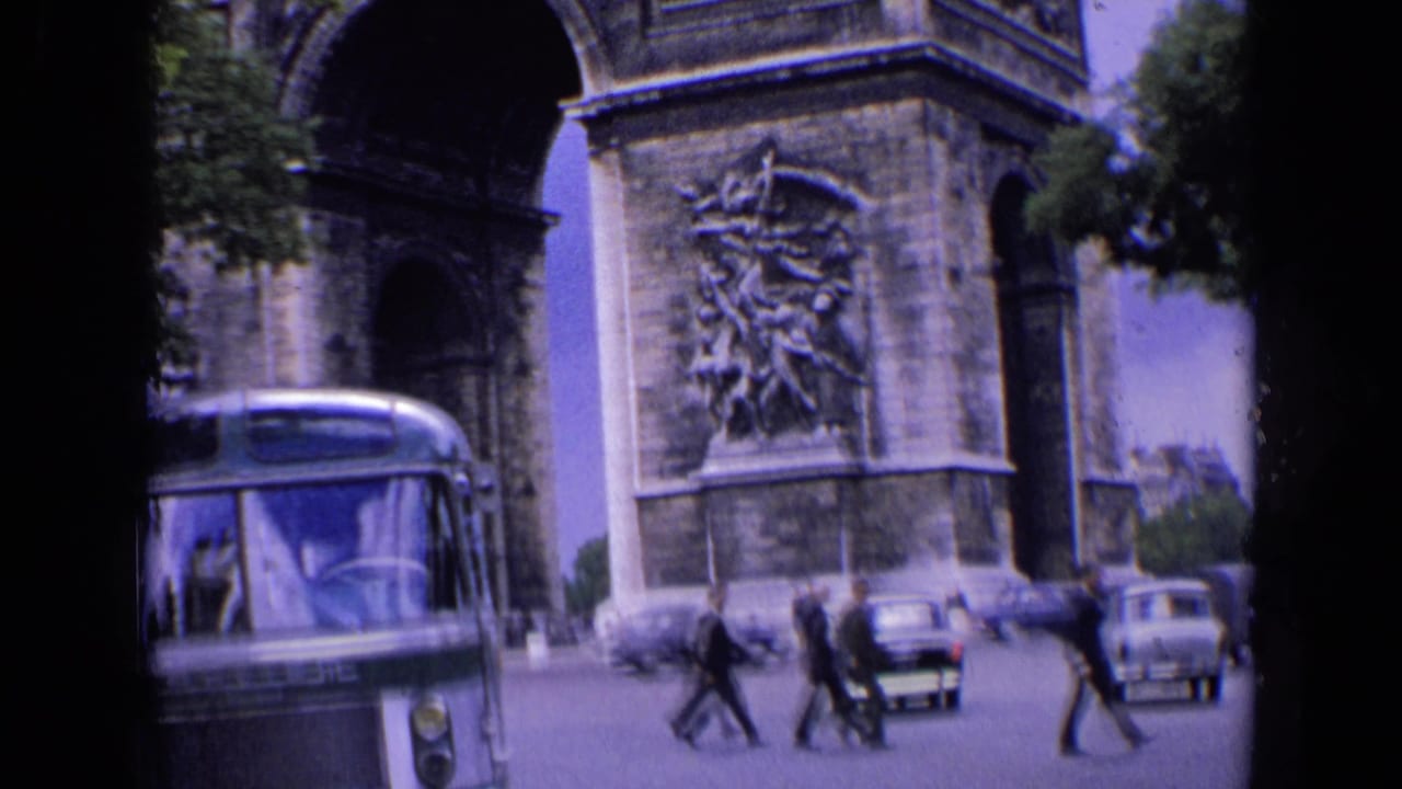 A bus, pedestrians, cars, and the Arc de Triomphe appear in a Paris street view.