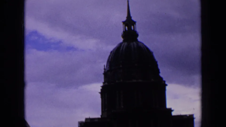 1963 France 8mm view of a church dome and cross-topped steeple, partially bordered by a dark vertical edge.